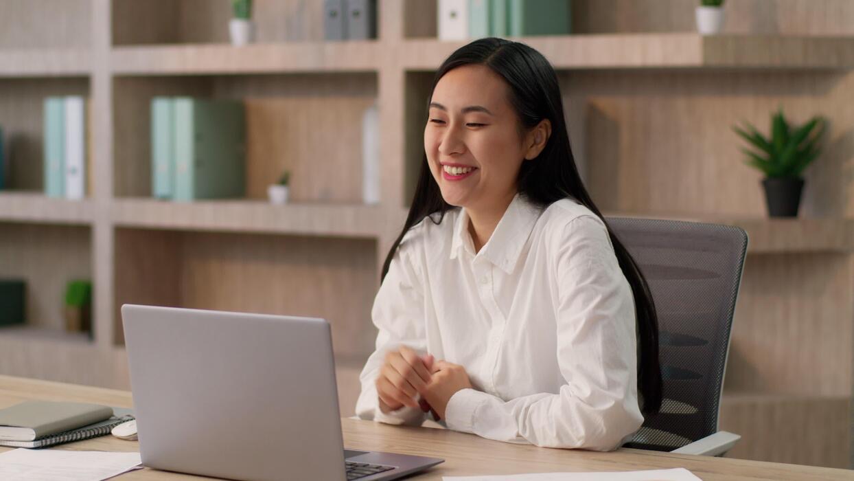 Support specialist smiling during a customer call